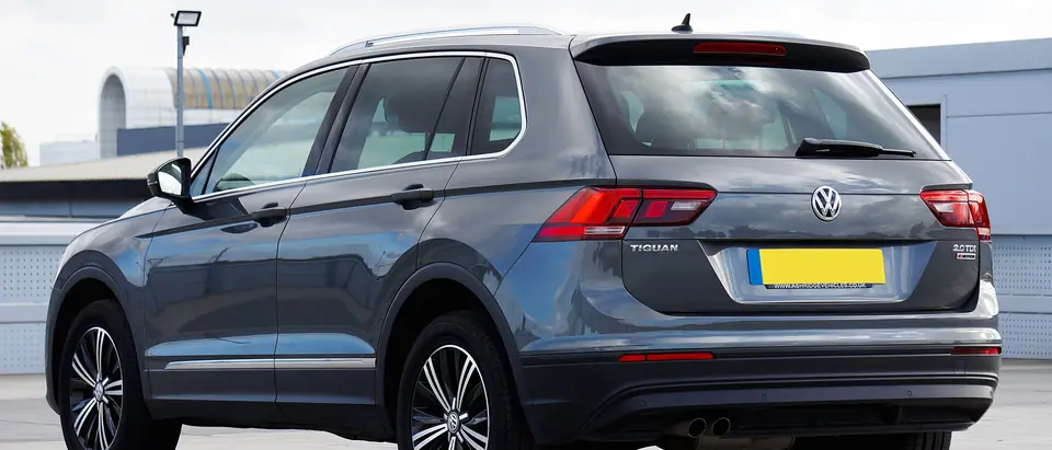 Rear window of a grey SUV in a lot